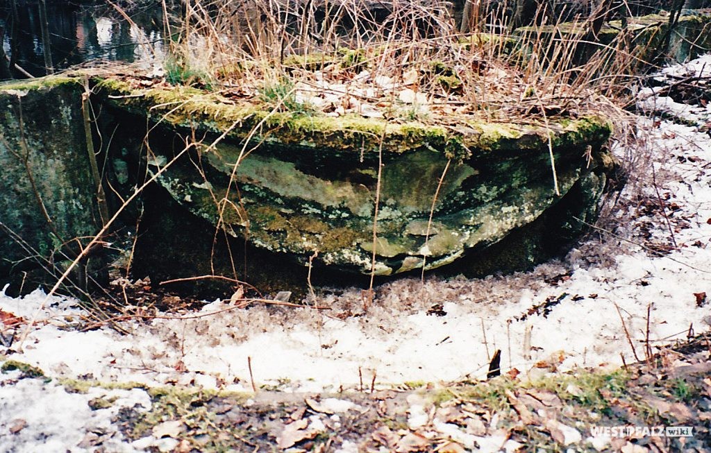 Pendant zur Brunnenschale beim Ritterstein Nr. 101 "Burgalbsprung". Sie steht im Karlstal, gegenüber des ehemaligen Gienanthschen Herrenhauses, am dort gelegenen Weiher. Einst wurde die Schale dekorativ bepflanzt.